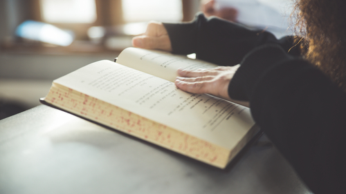 person reading torah at podium